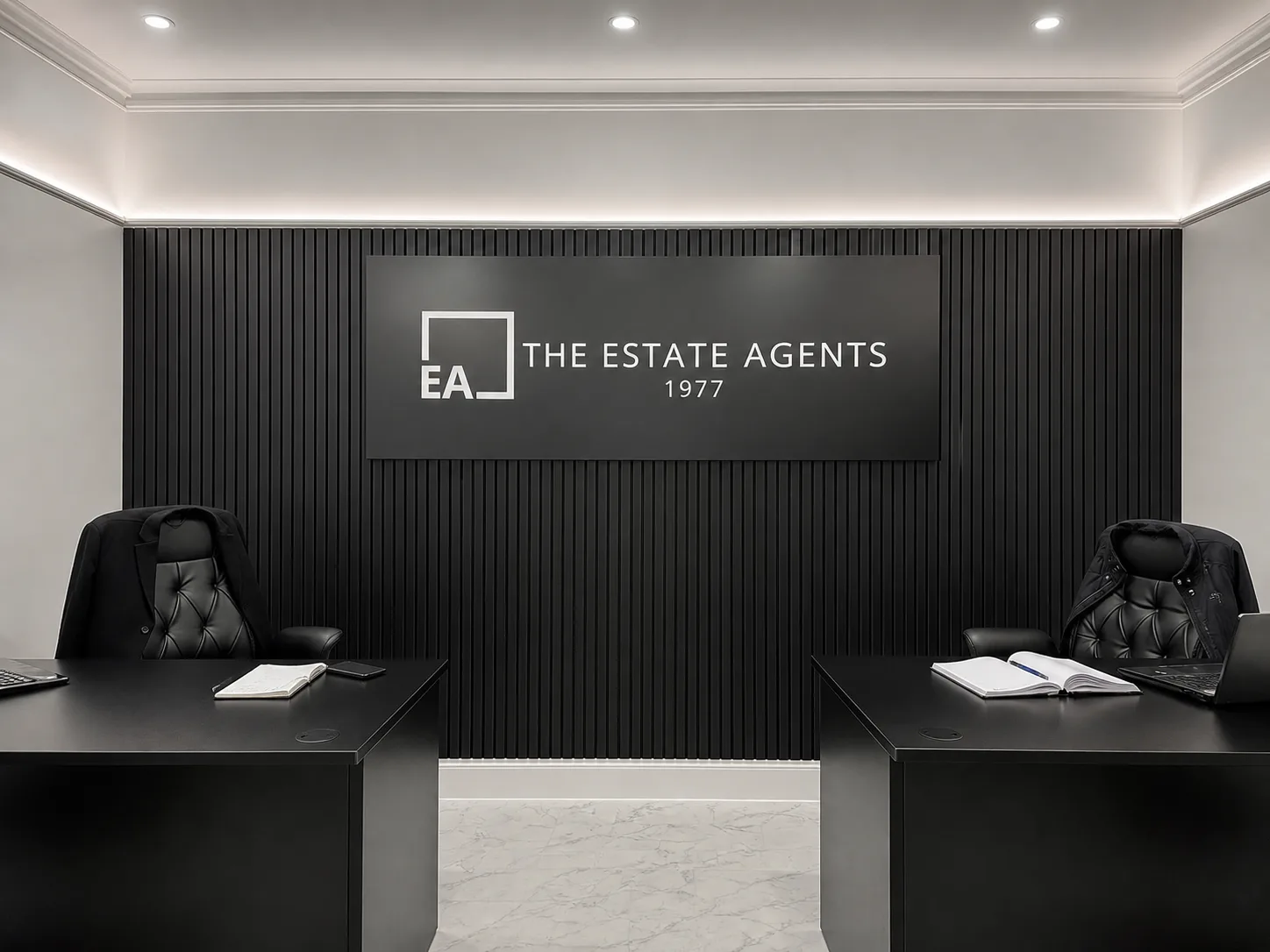 Black and white branded reception wall sign for The Estate Agents 1977